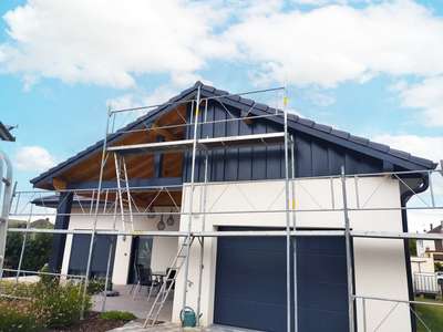 Maison en rénovation sous échafaudage, façade mêlant enduit et bardage bois